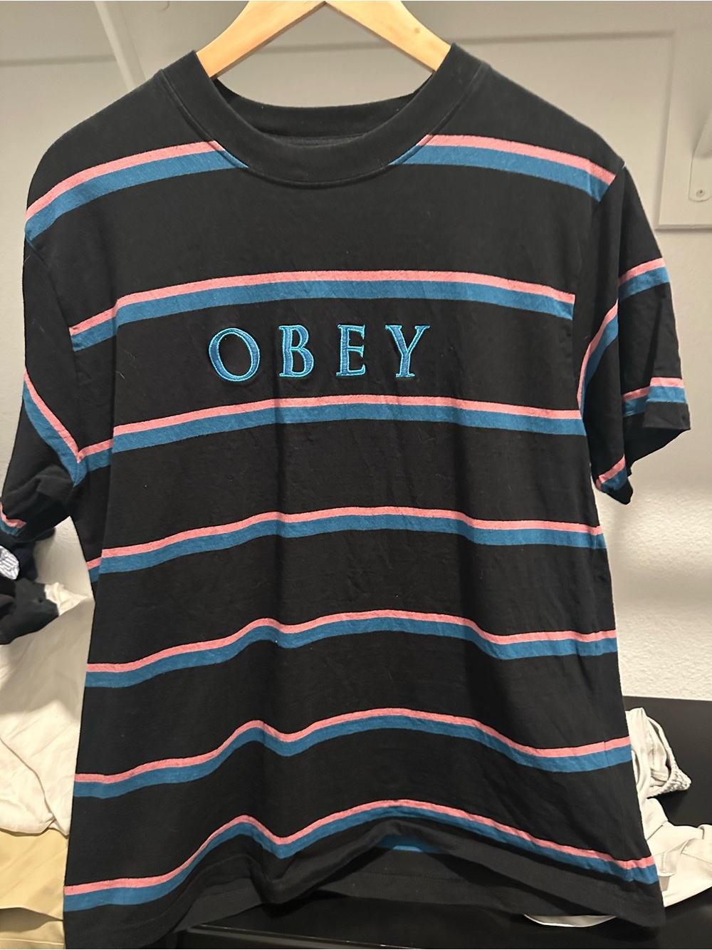 OBEY Men’s Black Stripe Logo T-Shirt in Blue & Pink